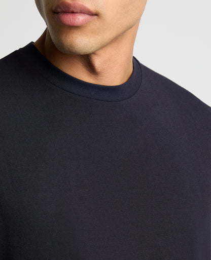 Man wearing a navy Relaxed Fit Crew Neck Tencel T-Shirt