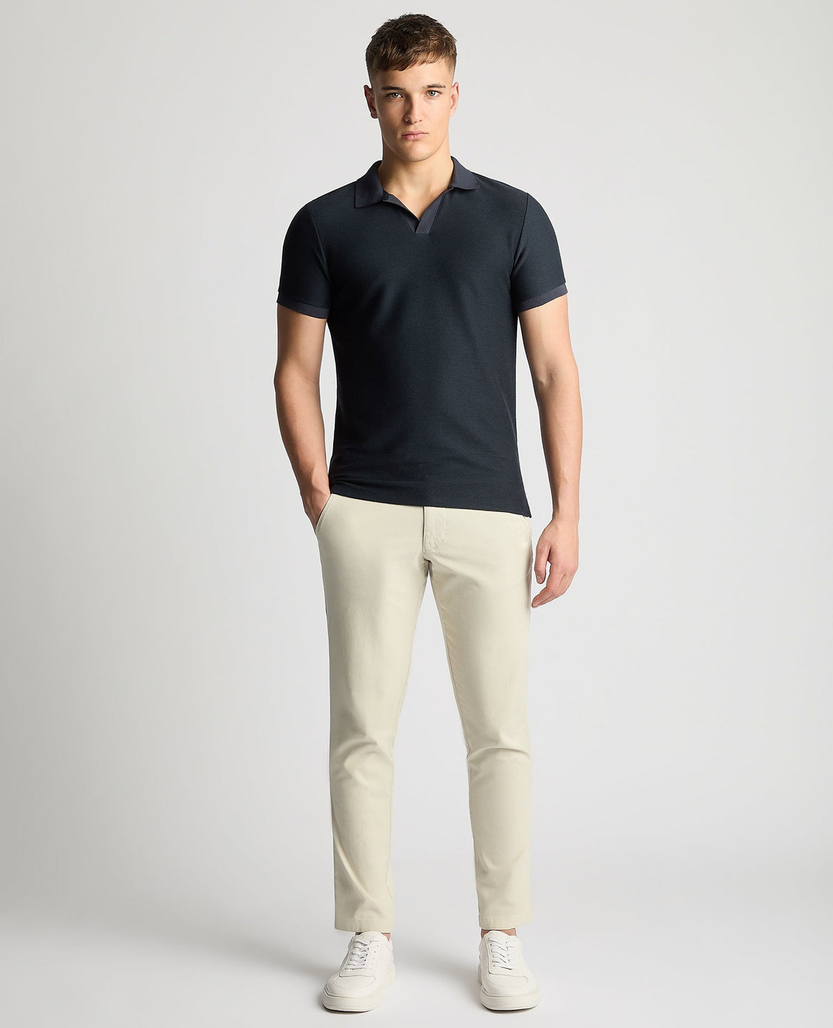 Man wearing a navy Tapered Fit Open Collar Polo