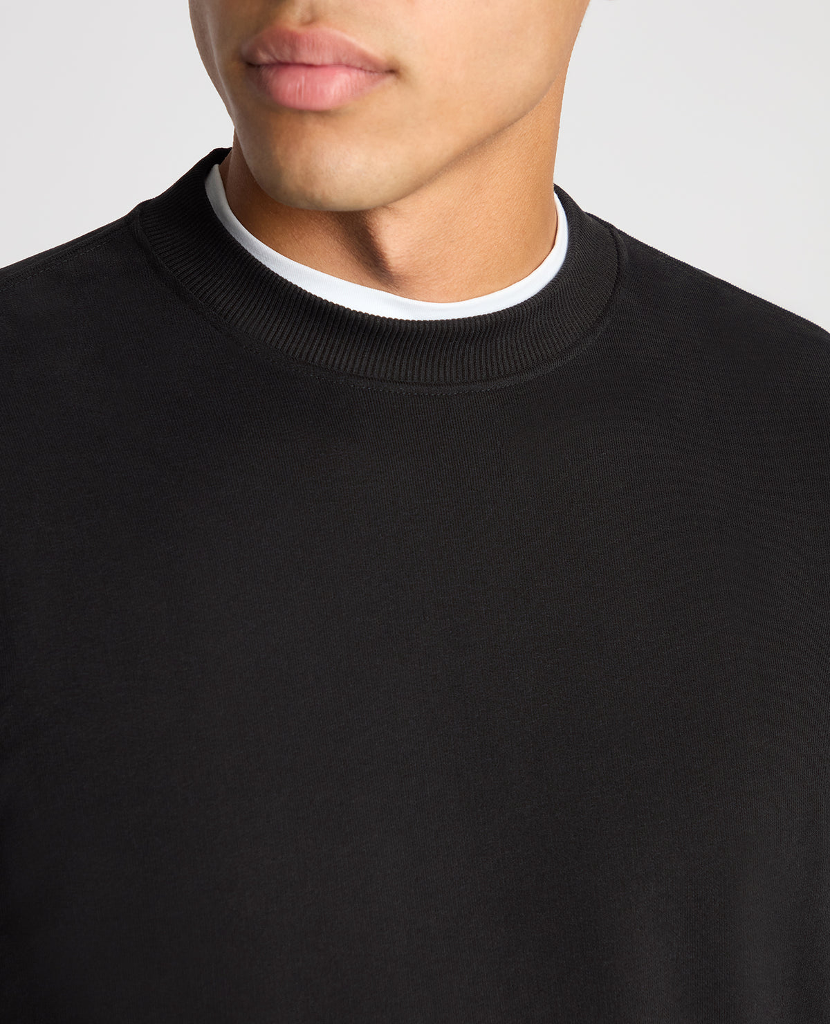 Man wearing a black Tapered Fit Soft Touch Cotton-Blend Sweatshirt