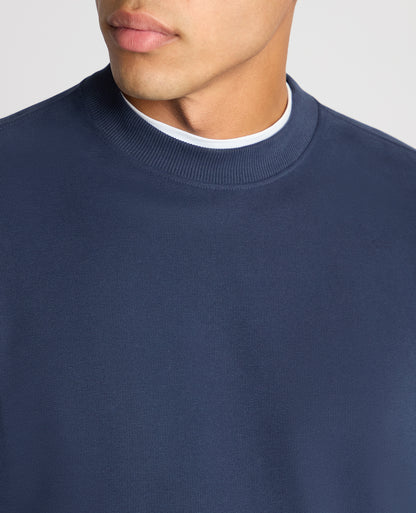 Man wearing a blue Tapered Fit Soft Touch Cotton-Blend Sweatshirt