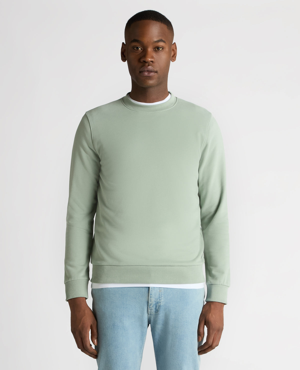 Man wearing a green Tapered Fit Soft Touch Cotton-Blend Sweatshirt