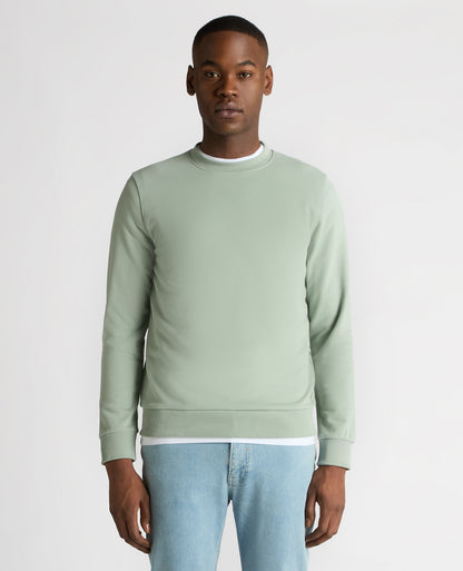 Man wearing a green Tapered Fit Soft Touch Cotton-Blend Sweatshirt