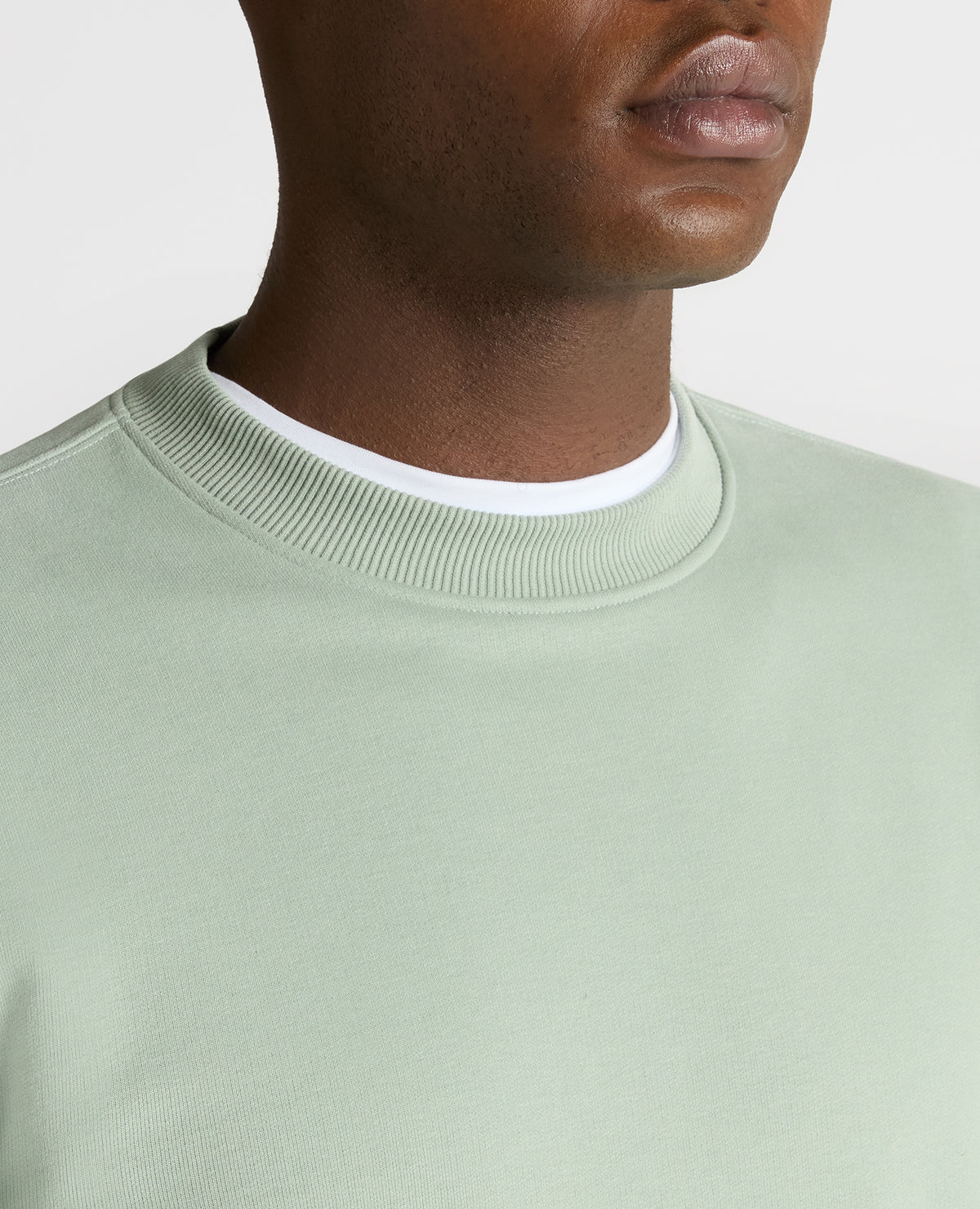 Man wearing a green Tapered Fit Soft Touch Cotton-Blend Sweatshirt