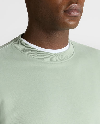 Man wearing a green Tapered Fit Soft Touch Cotton-Blend Sweatshirt