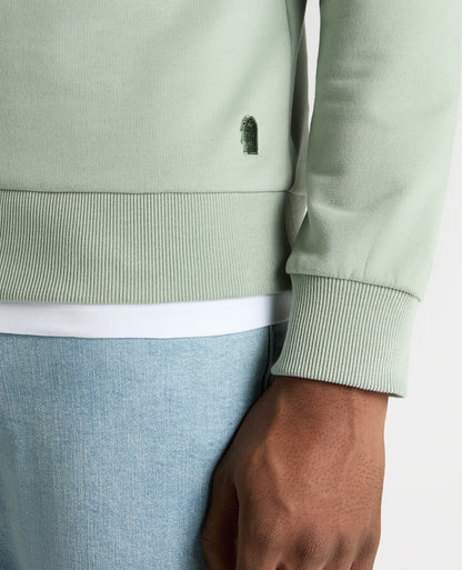 Man wearing a green Tapered Fit Soft Touch Cotton-Blend Sweatshirt