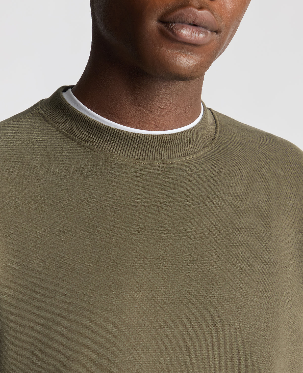 Man wearing a green Tapered Fit Soft Touch Cotton-Blend Sweatshirt