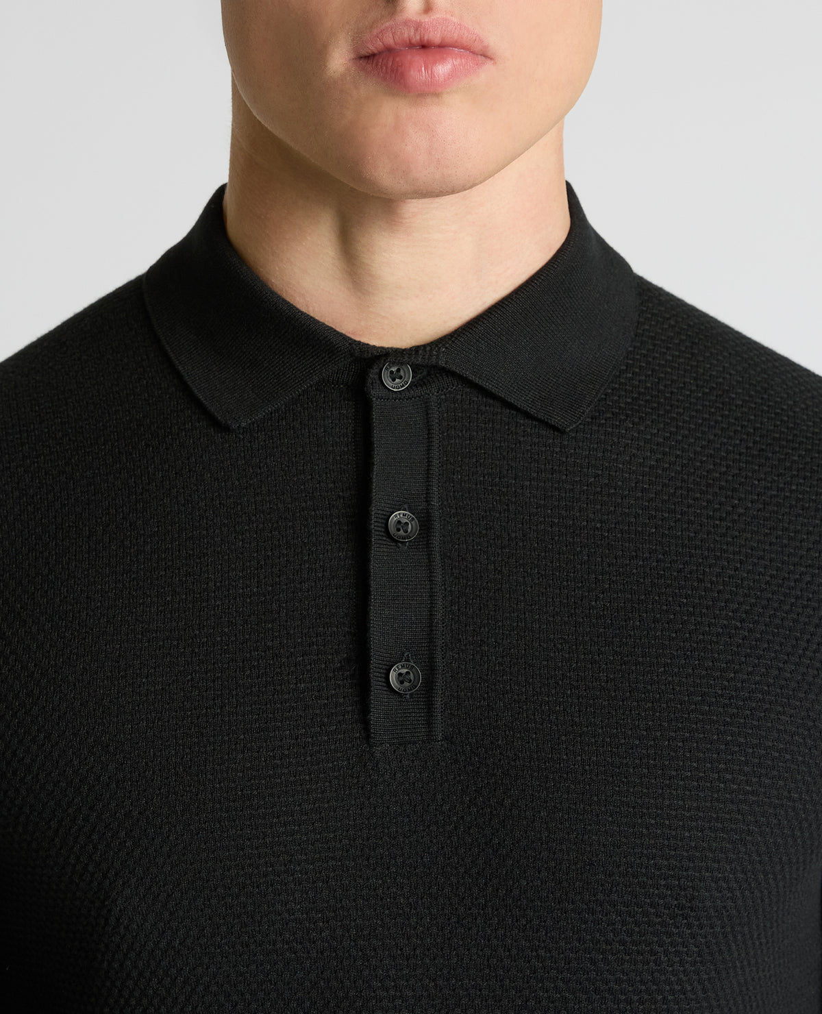 Man wearing a black Cotton Interest Fabric Knit Polo