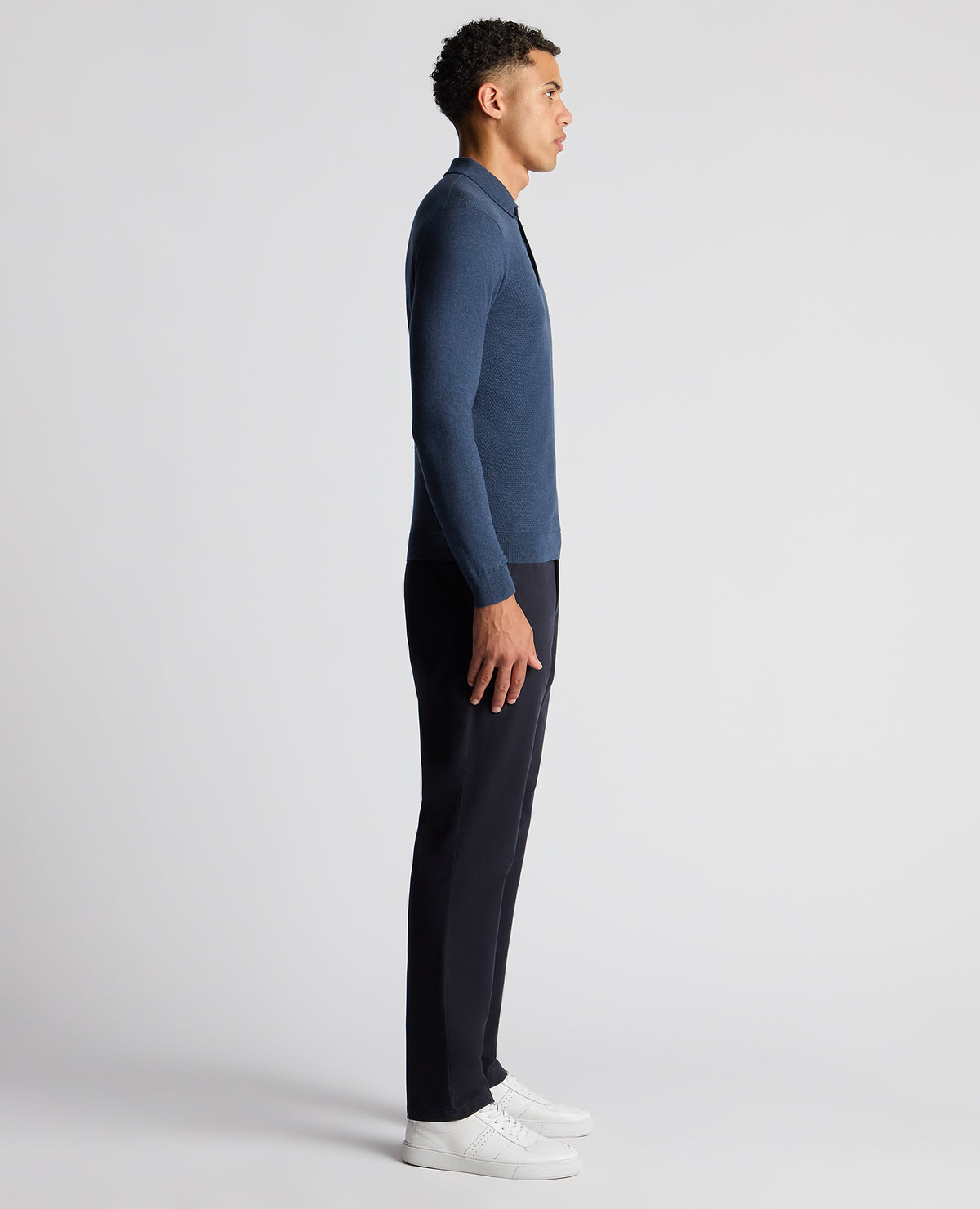 Man wearing a blue Slim Fit Cotton Knitted Polo