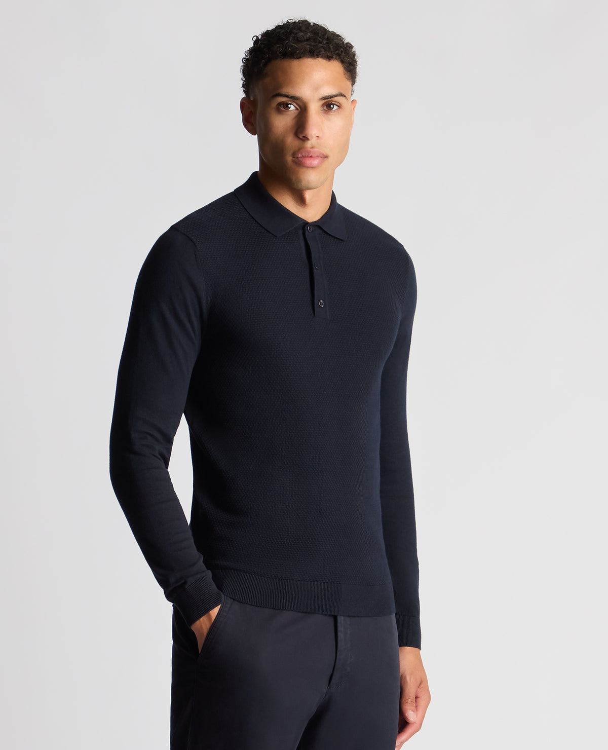Man wearing a navy Slim Fit Cotton Knitted Polo