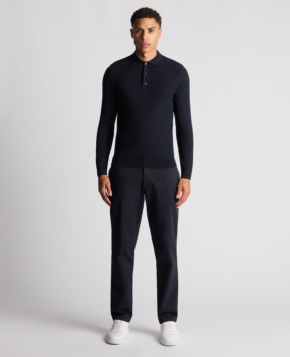 Man wearing a navy Slim Fit Cotton Knitted Polo