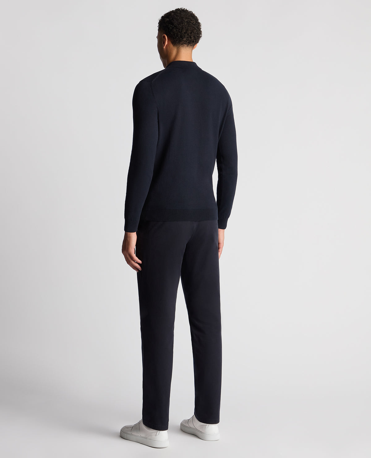 Man wearing a navy Slim Fit Cotton Knitted Polo