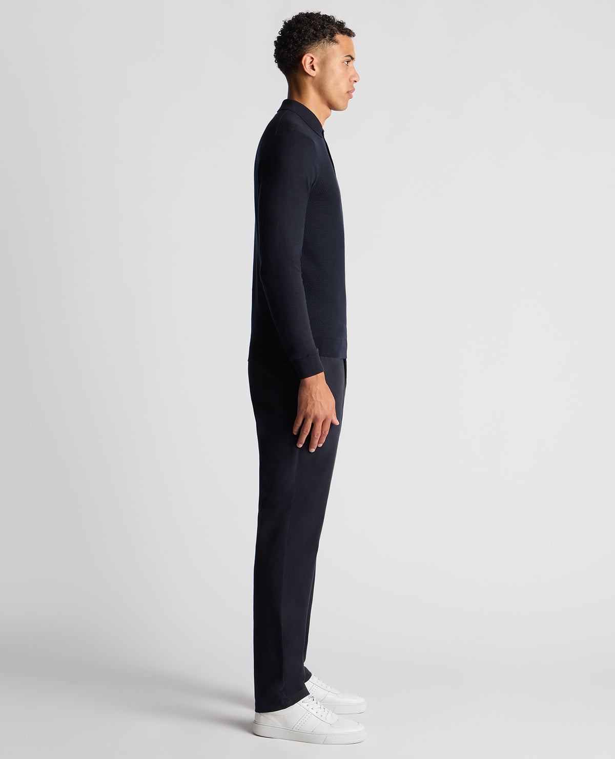 Man wearing a navy Slim Fit Cotton Knitted Polo