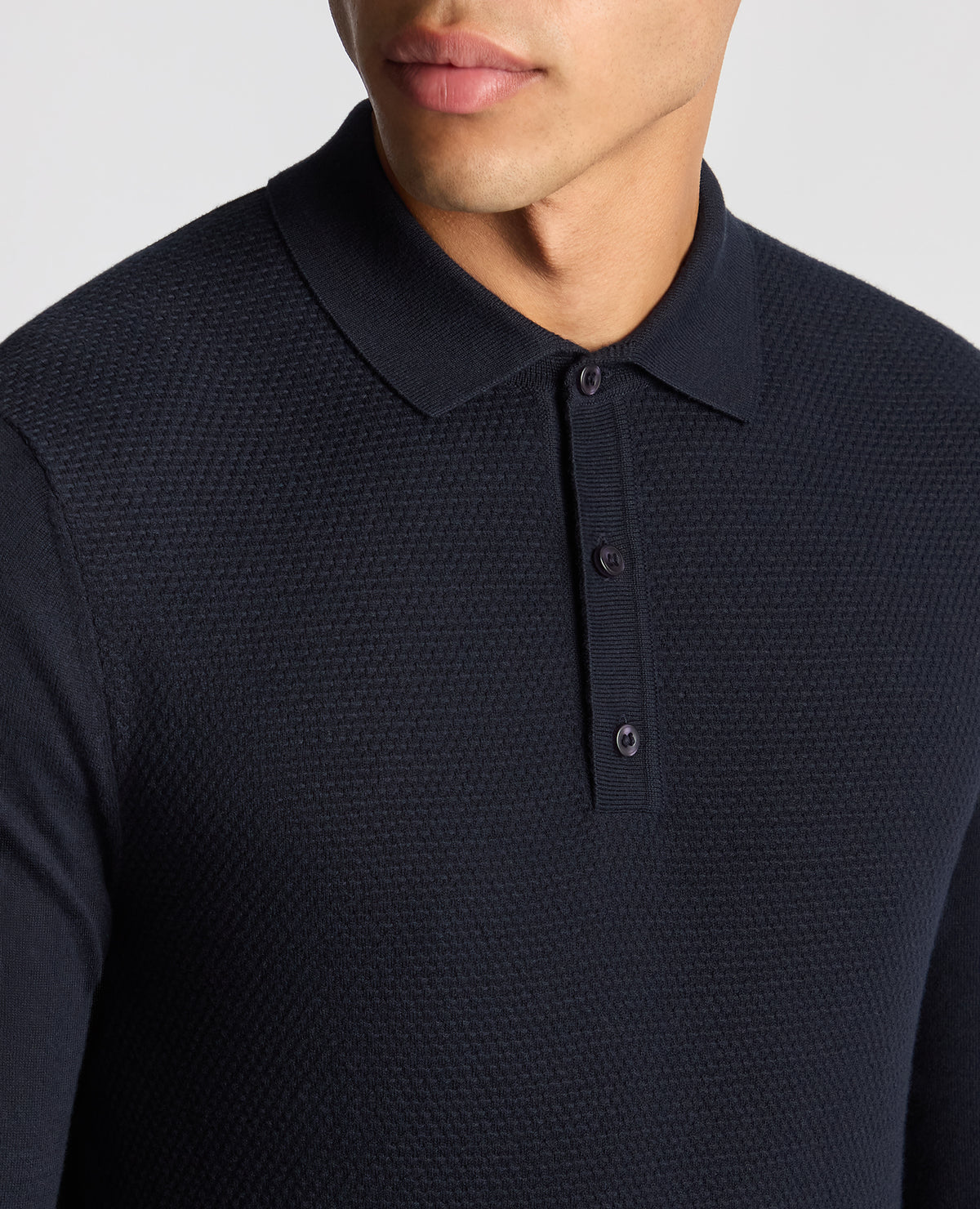 Man wearing a navy Slim Fit Cotton Knitted Polo