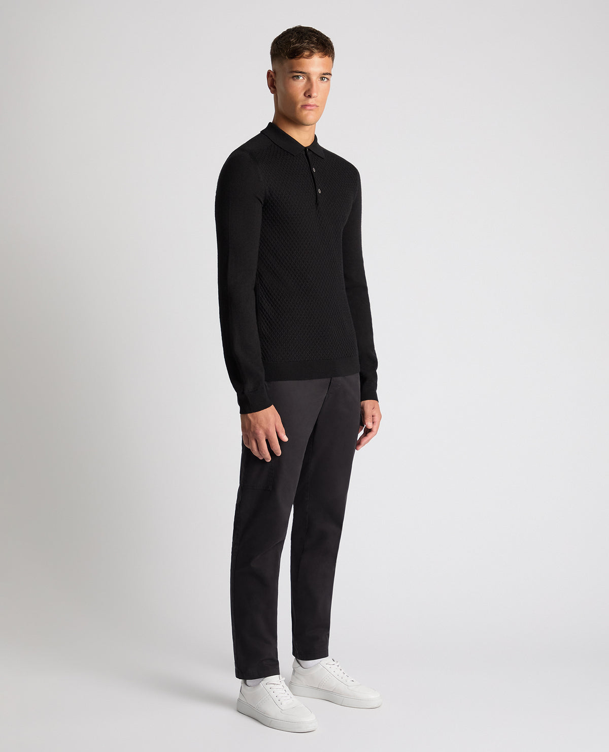 Man wearing a black Slim Fit Merino Wool-Blend Knitted Polo