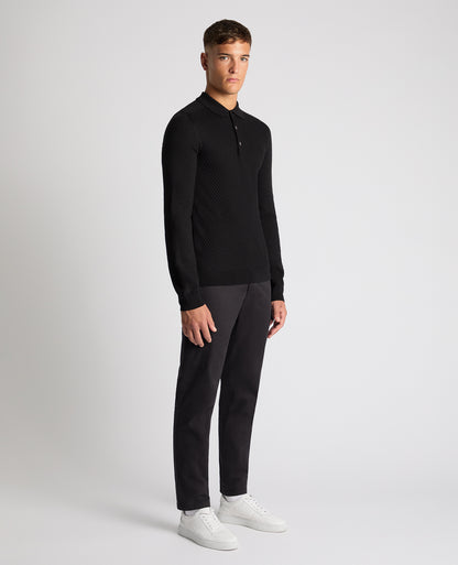 Man wearing a black Slim Fit Merino Wool-Blend Knitted Polo