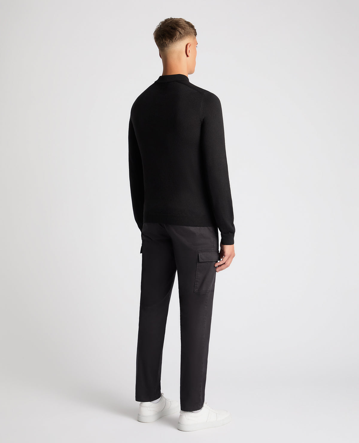 Man wearing a black Slim Fit Merino Wool-Blend Knitted Polo