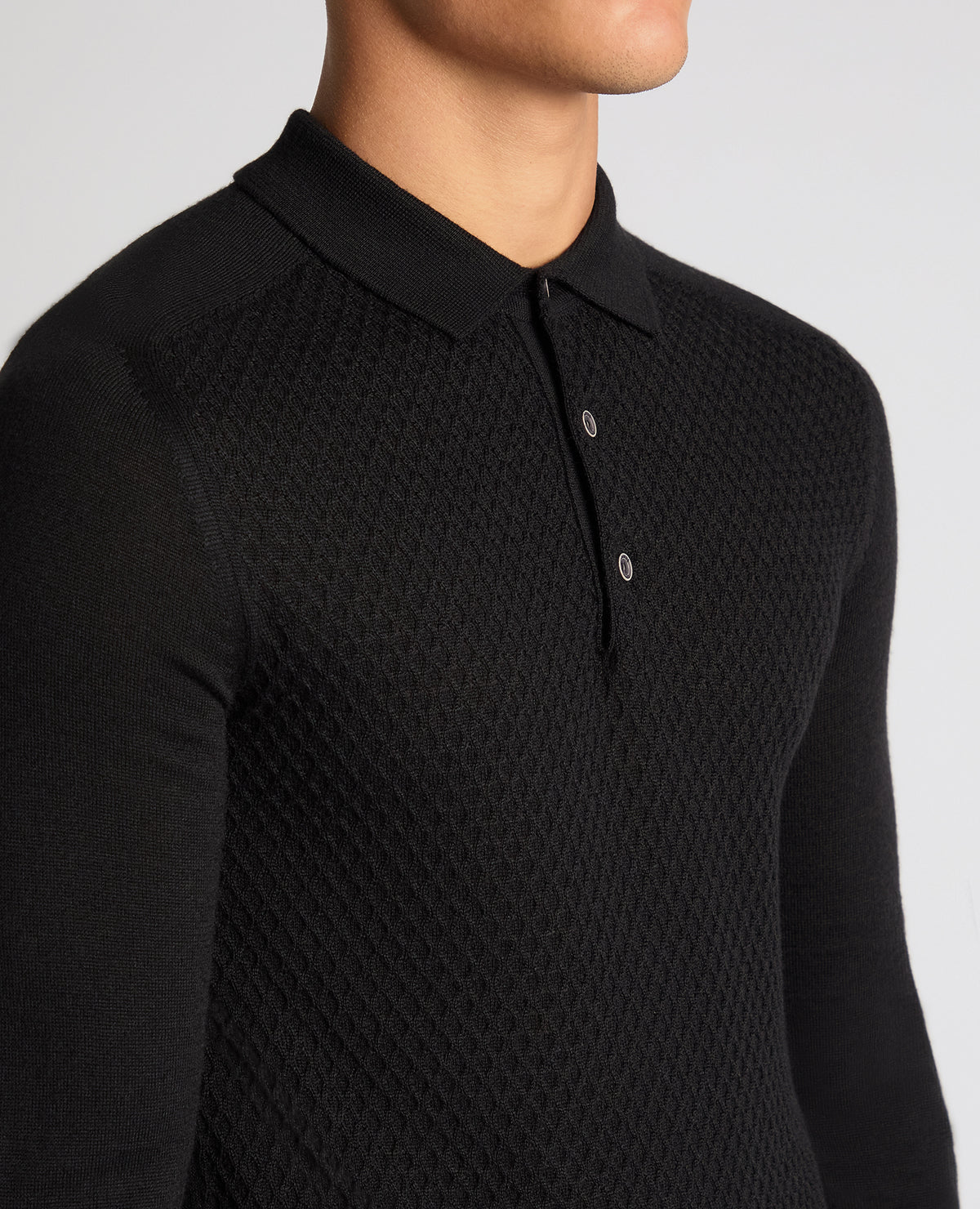 Man wearing a black Slim Fit Merino Wool-Blend Knitted Polo