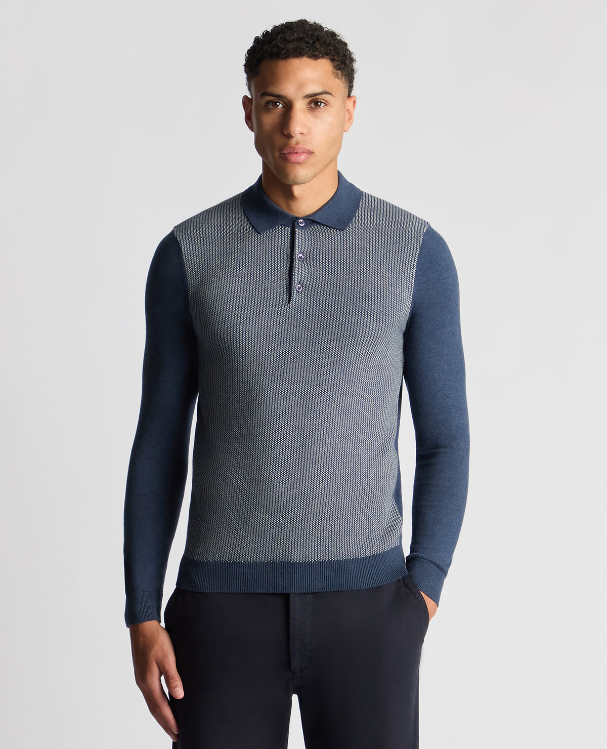 Man wearing a blue Slim Fit Merino Cotton Jacquard Knitted Polo