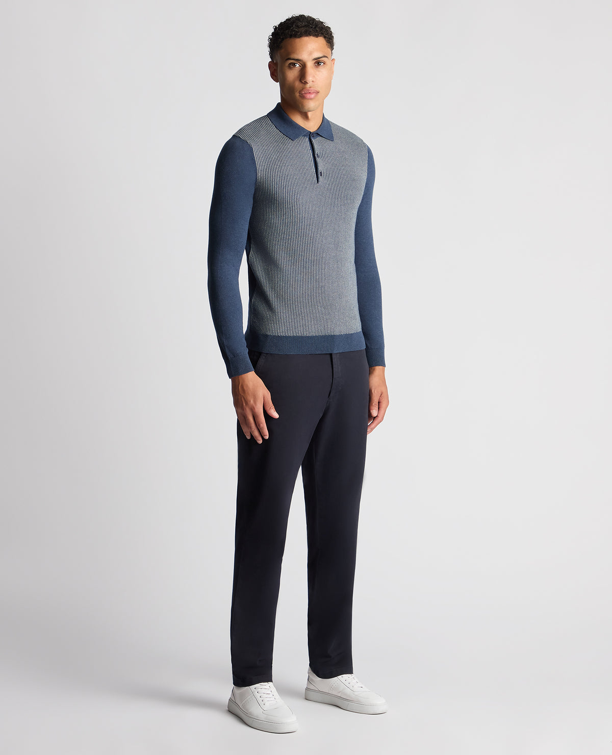 Man wearing a blue Slim Fit Merino Cotton Jacquard Knitted Polo