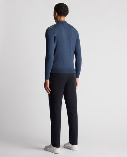 Man wearing a blue Slim Fit Merino Cotton Jacquard Knitted Polo