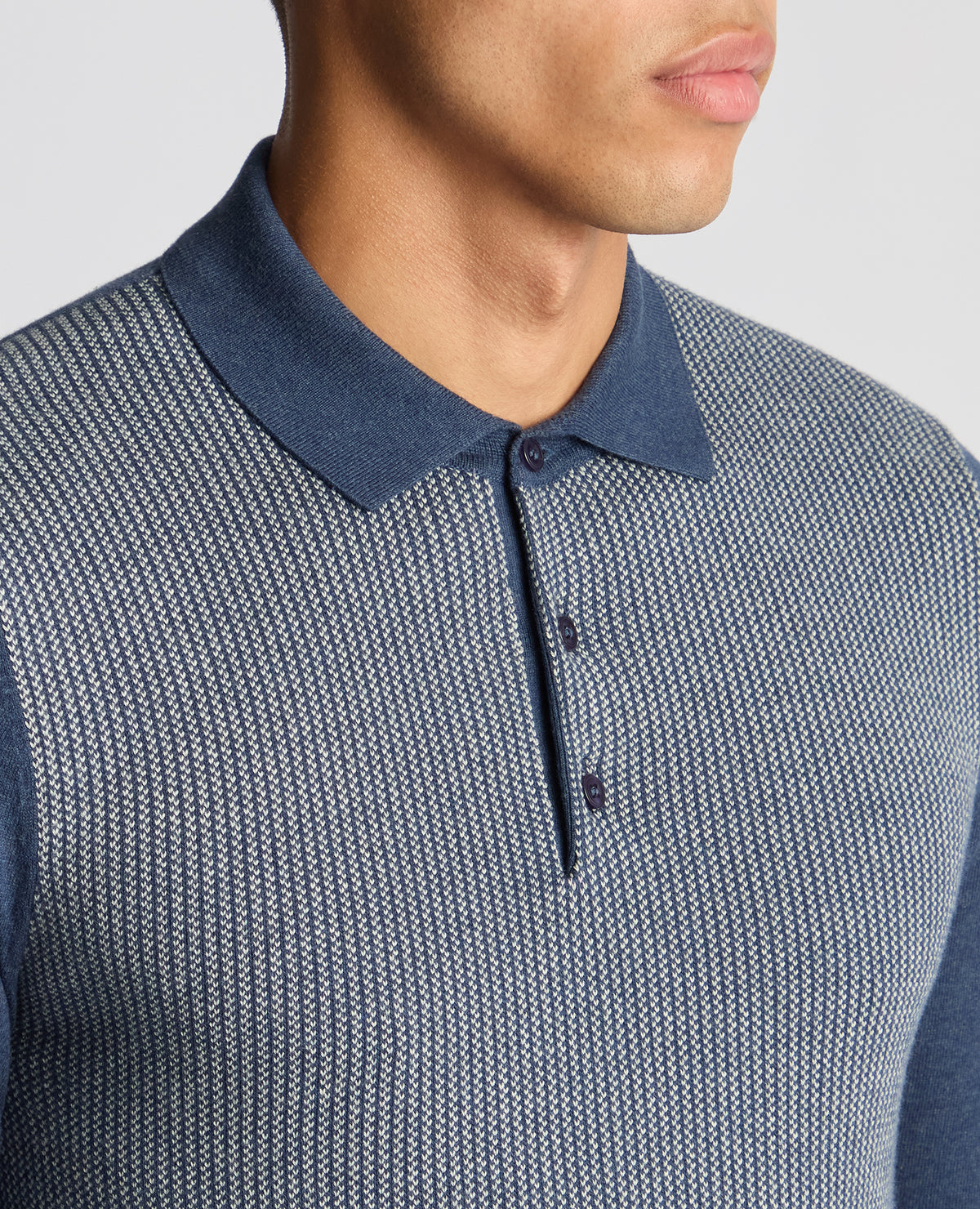 Man wearing a blue Slim Fit Merino Cotton Jacquard Knitted Polo