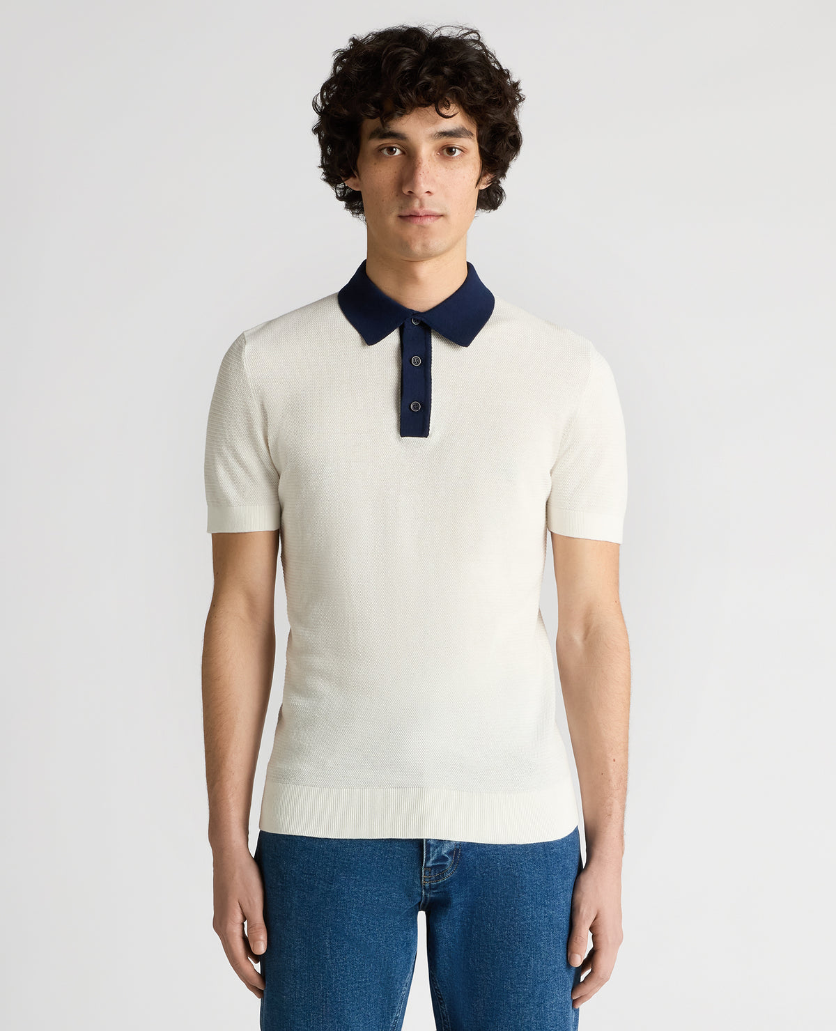 Man wearing a white Slim Fit Cotton Polo Shirt