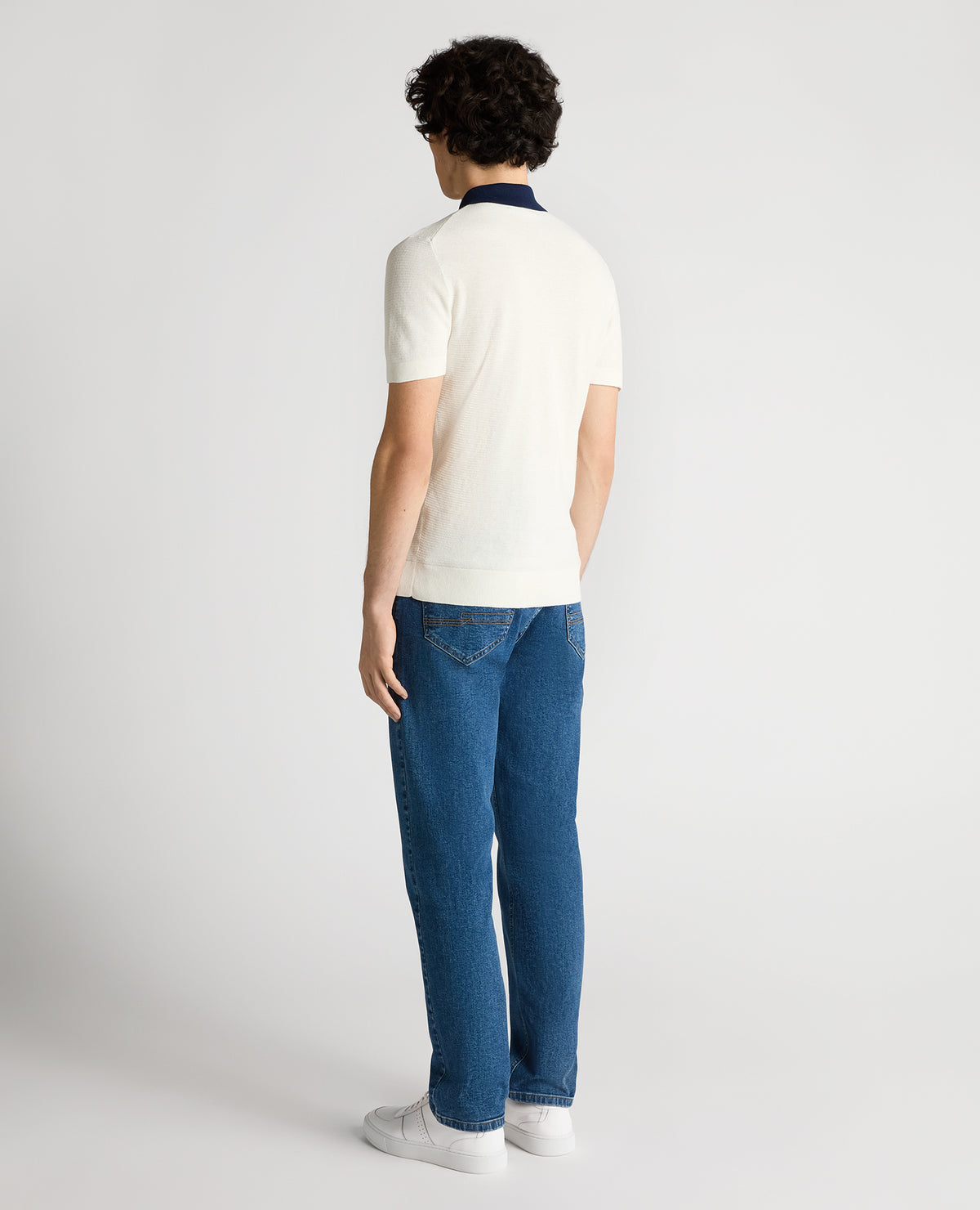 Man wearing a white Slim Fit Cotton Polo Shirt
