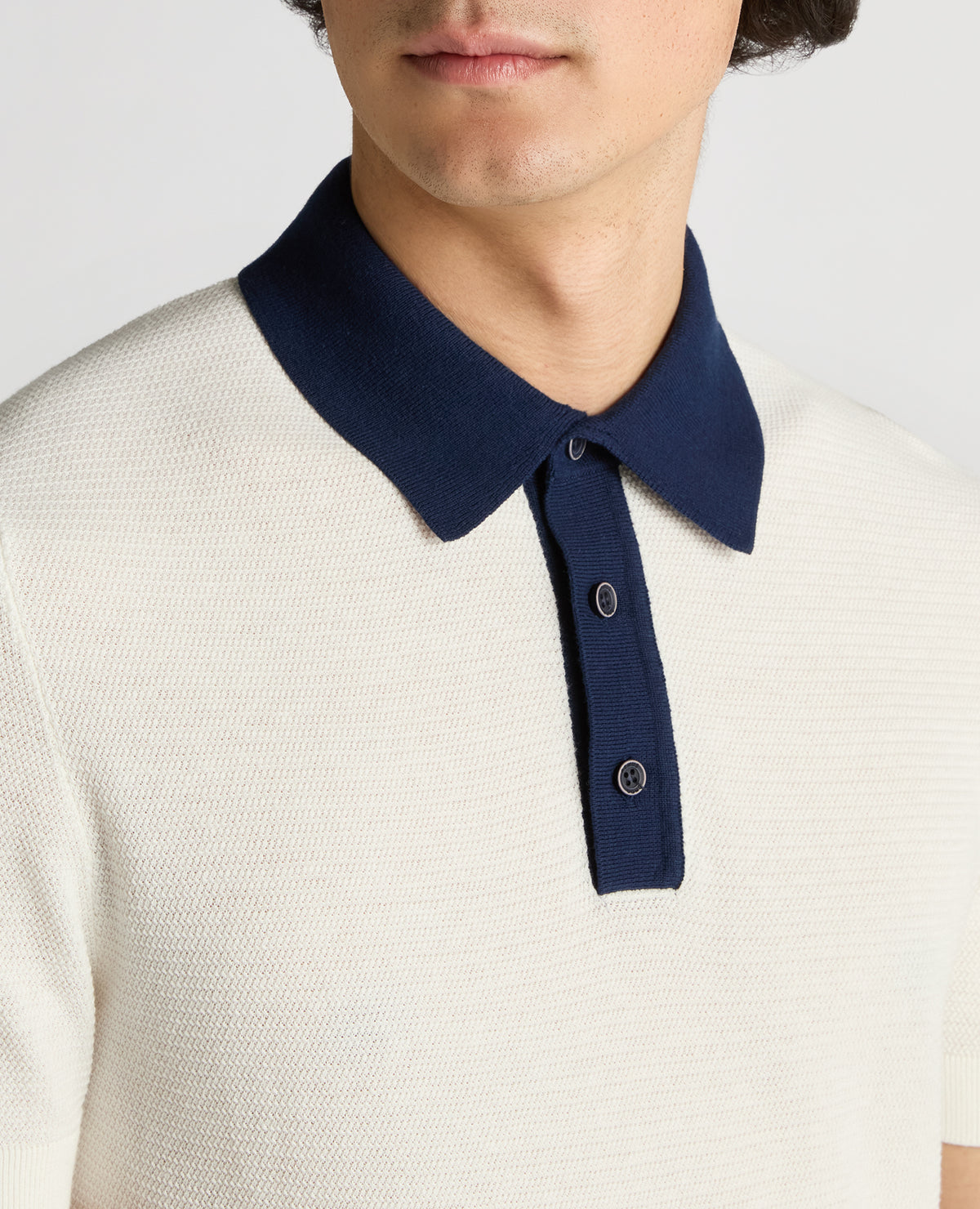 Man wearing a white Slim Fit Cotton Polo Shirt
