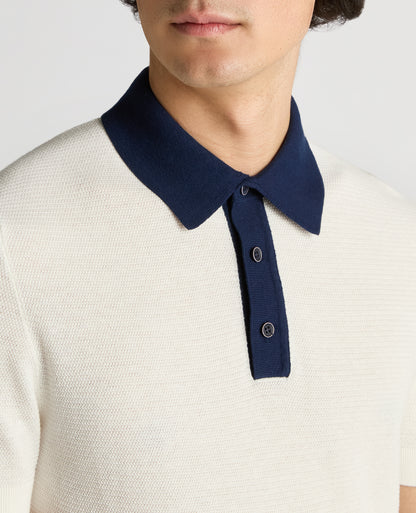 Man wearing a white Slim Fit Cotton Polo Shirt