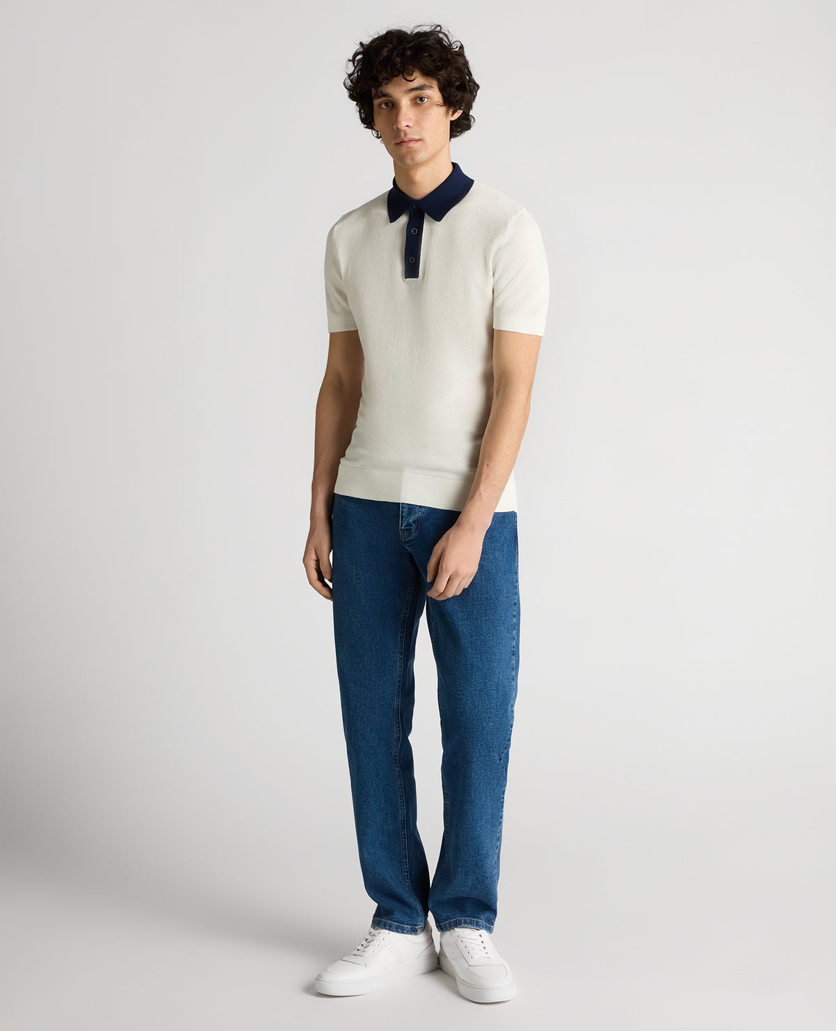 Man wearing a white Slim Fit Cotton Polo Shirt