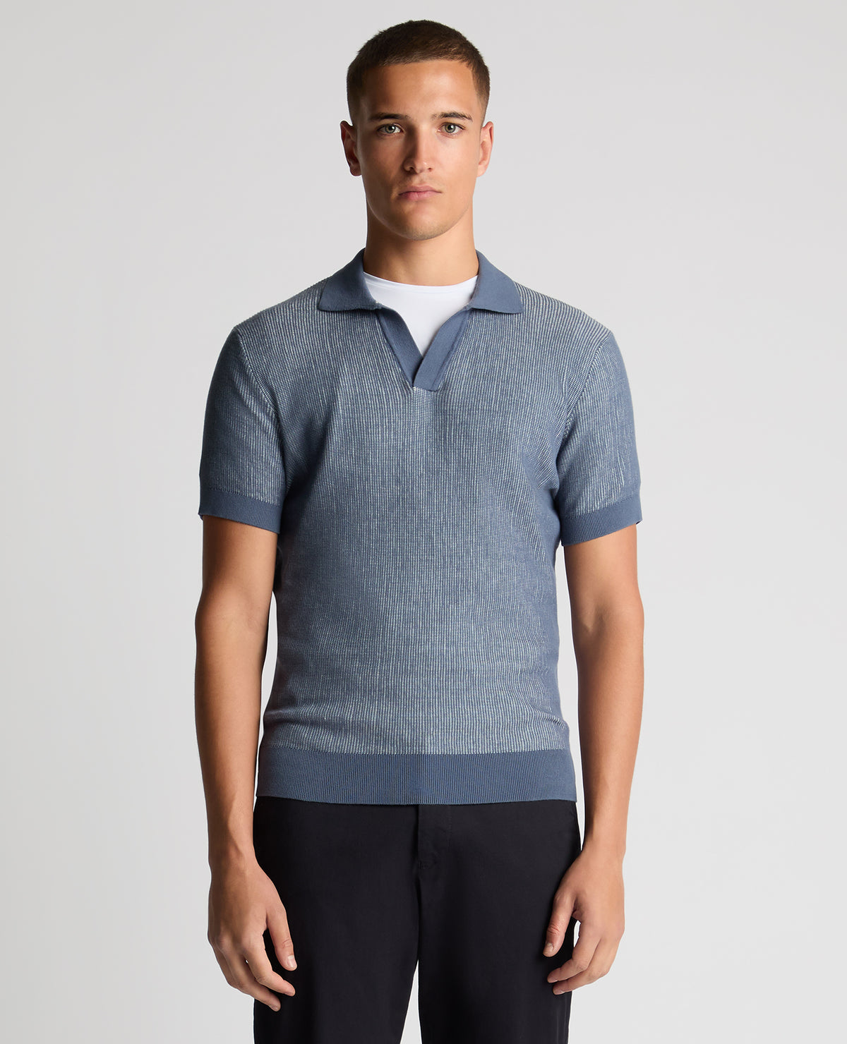 Man wearing a blue Slim Fit Textured Knit Polo