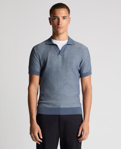 Man wearing a blue Slim Fit Textured Knit Polo