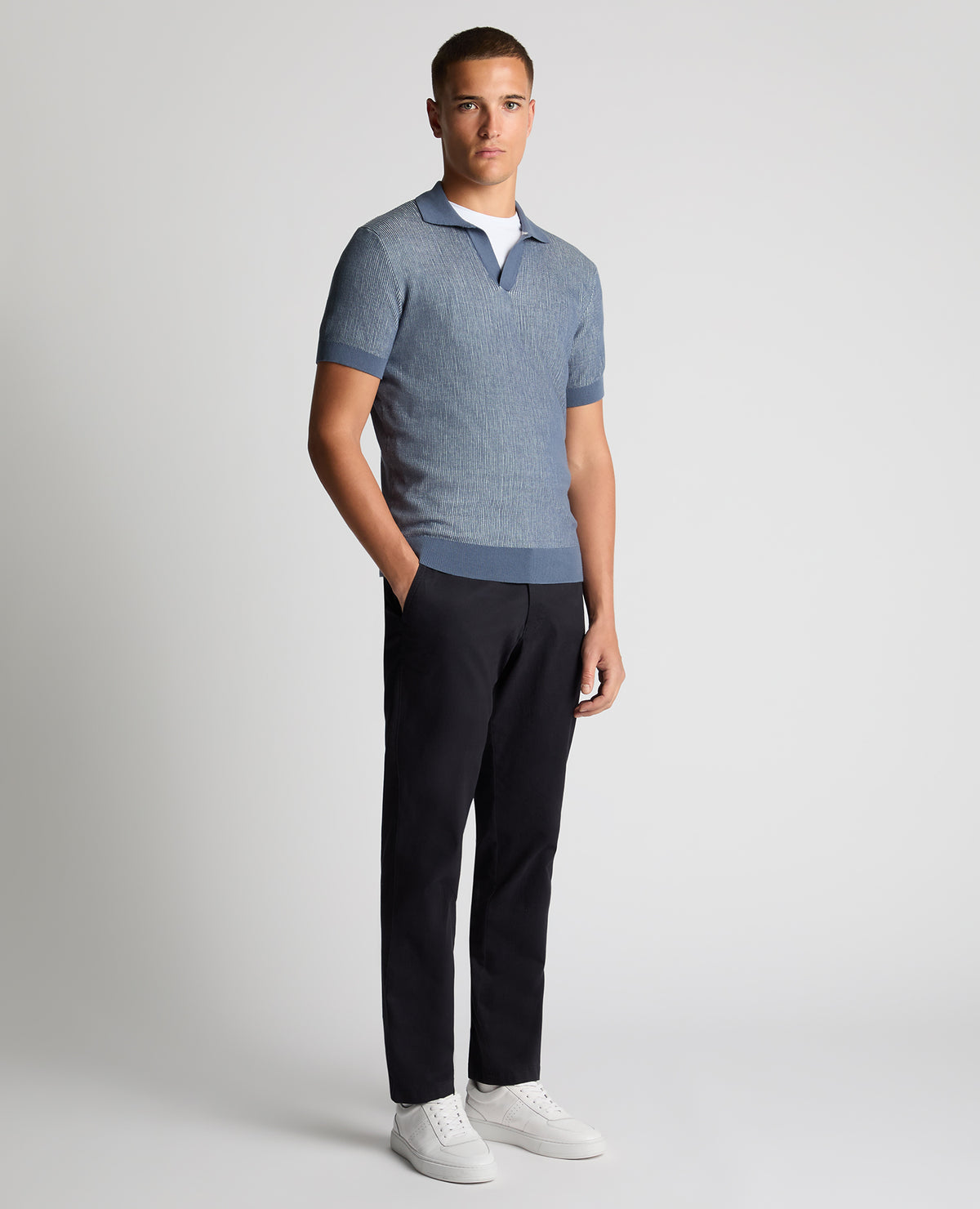 Man wearing a blue Slim Fit Textured Knit Polo