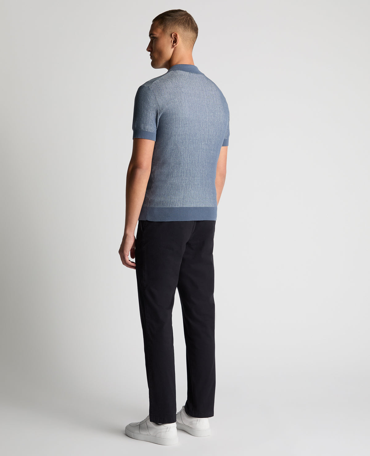 Man wearing a blue Slim Fit Textured Knit Polo