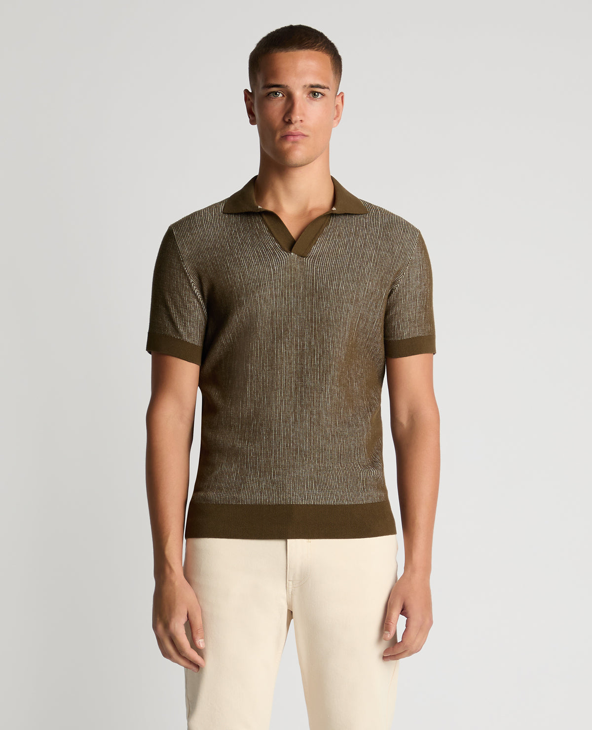 Man wearing a green Slim Fit Textured Knit Polo