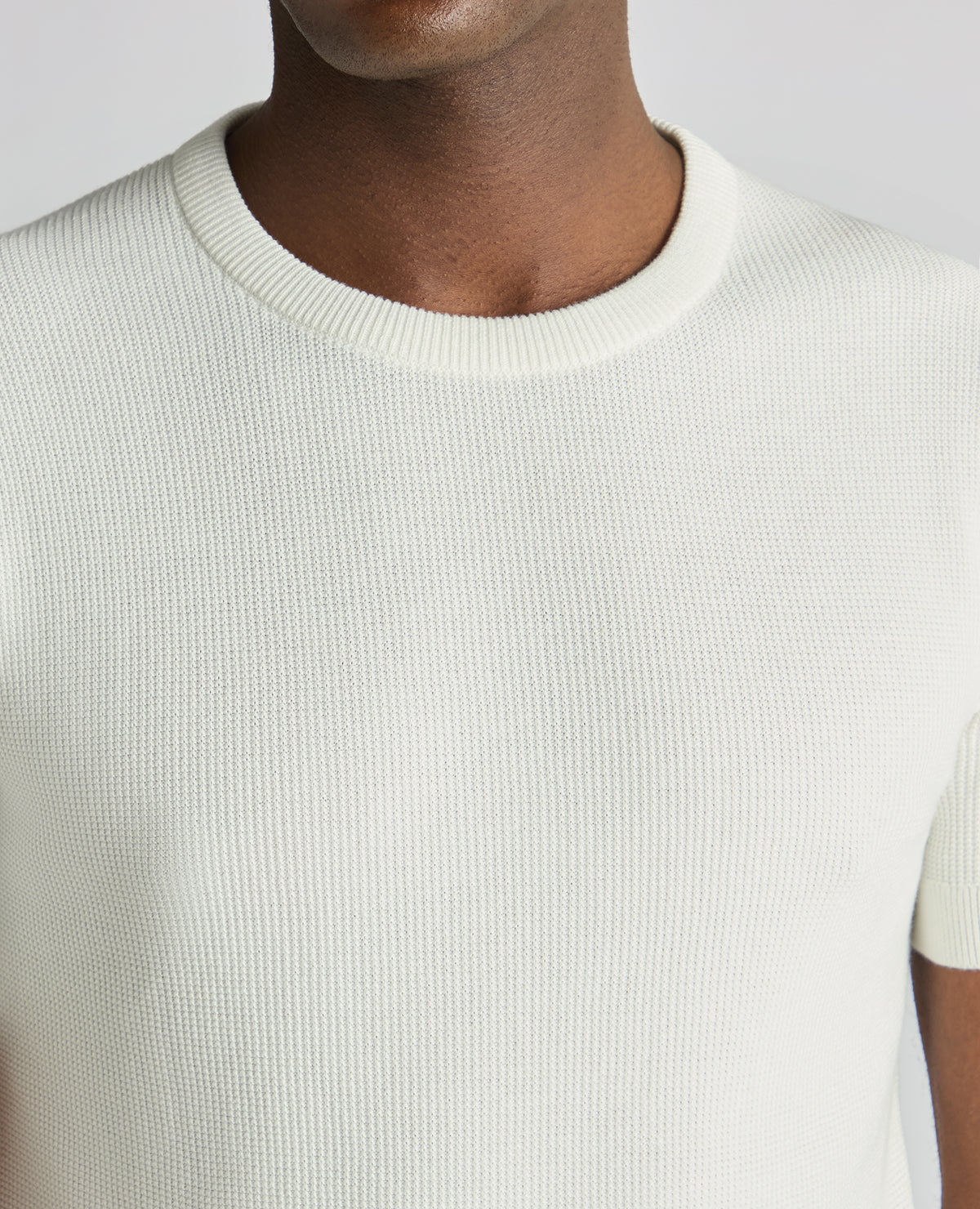 Man wearing a white Slim Fit Wafffle Knitted Tee