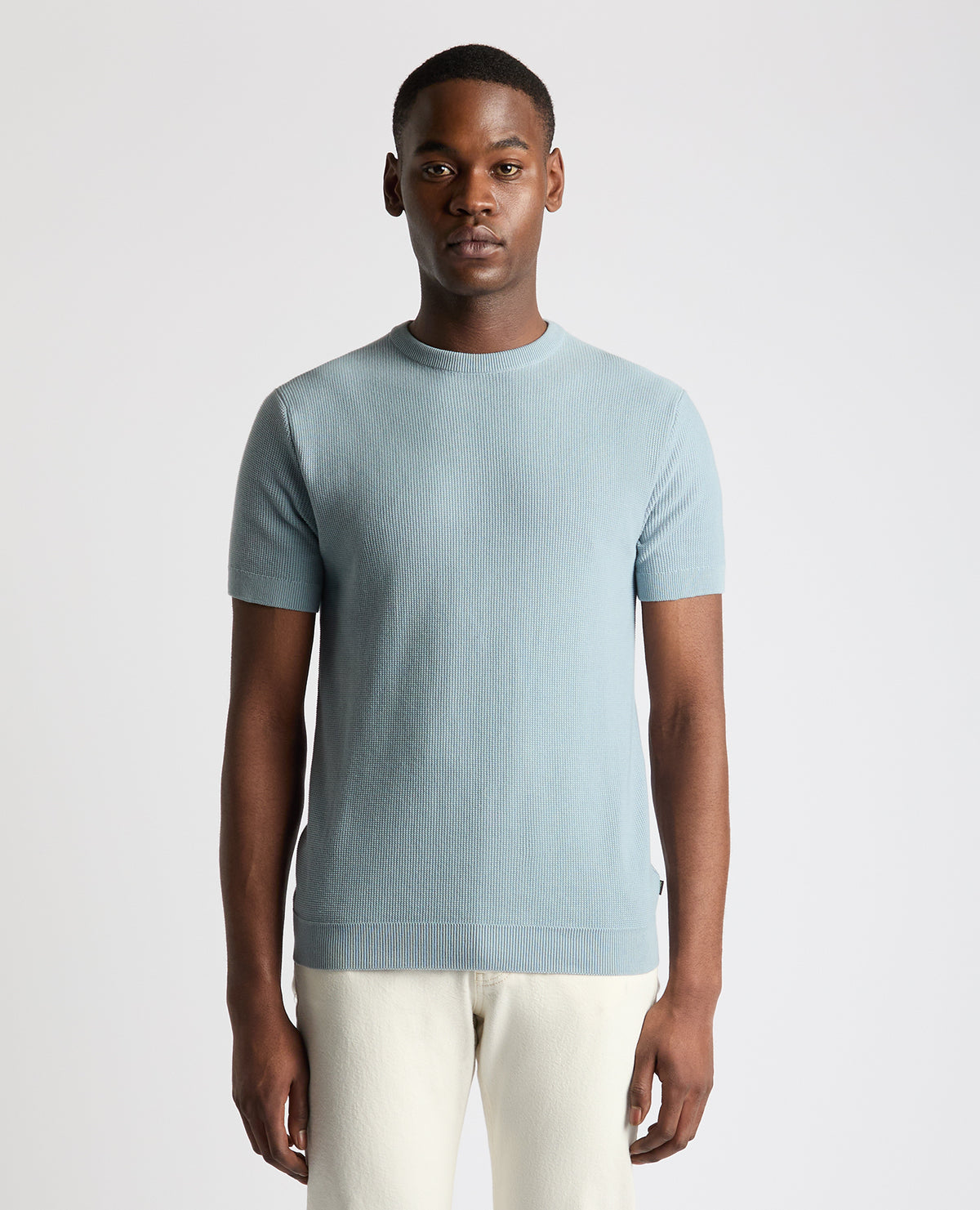 Man wearing a blue Slim Fit Wafffle Knitted Tee