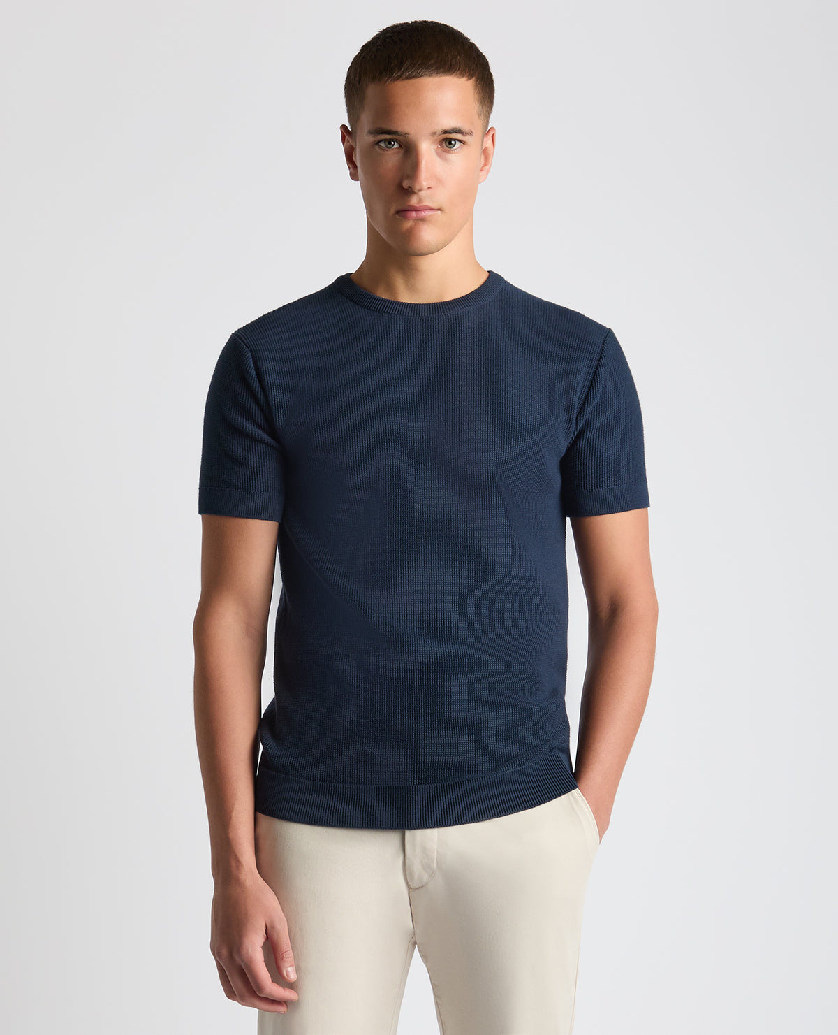 Man wearing a navy Slim Fit Wafffle Knitted Tee