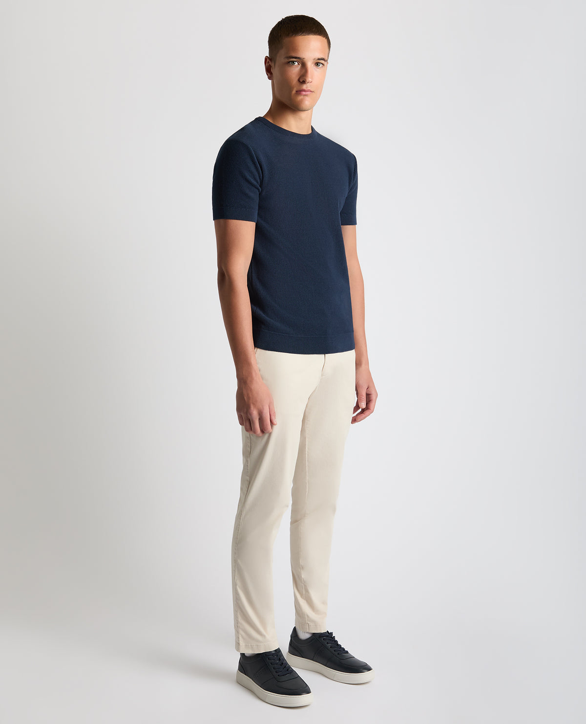 Man wearing a navy Slim Fit Wafffle Knitted Tee