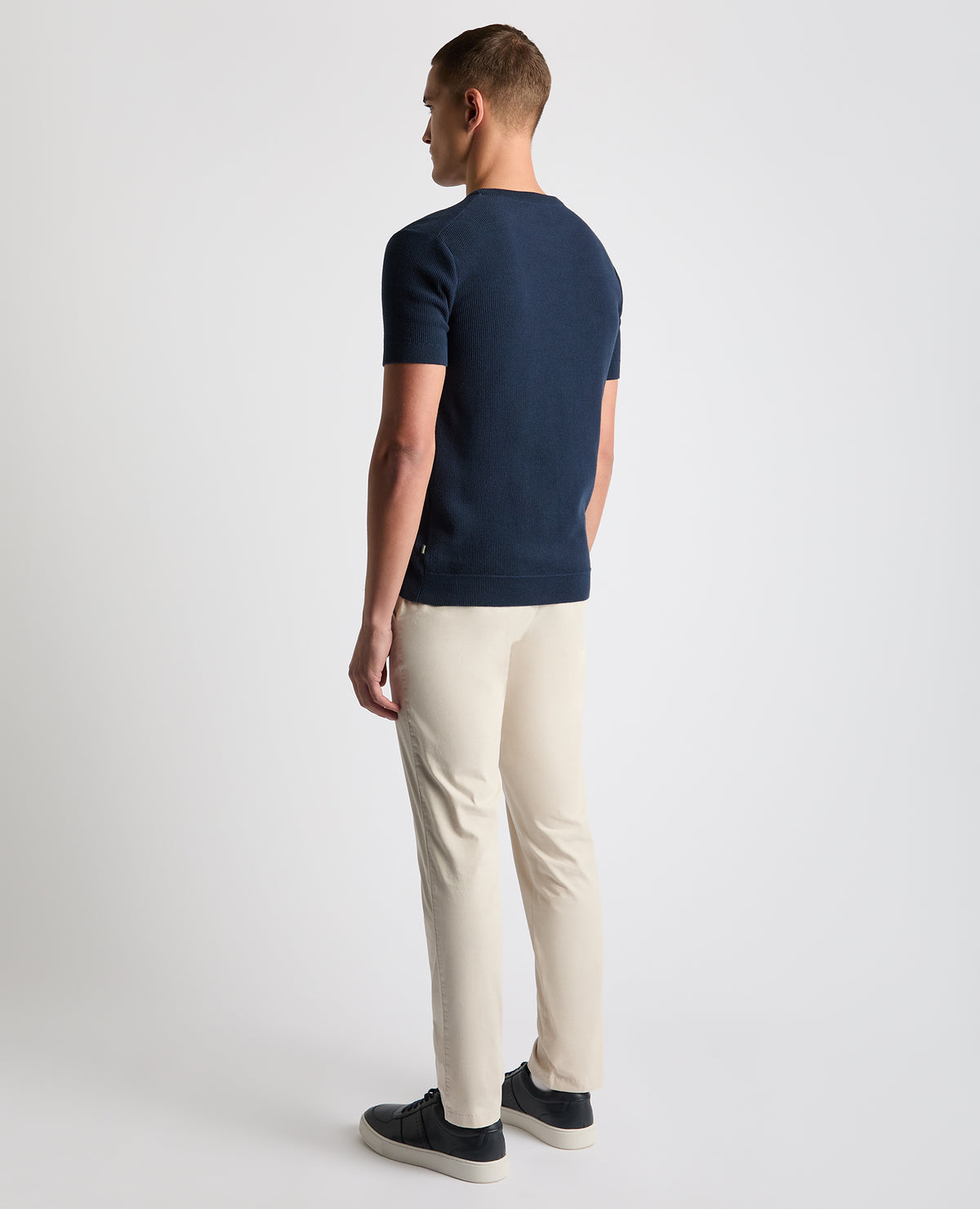 Man wearing a navy Slim Fit Wafffle Knitted Tee
