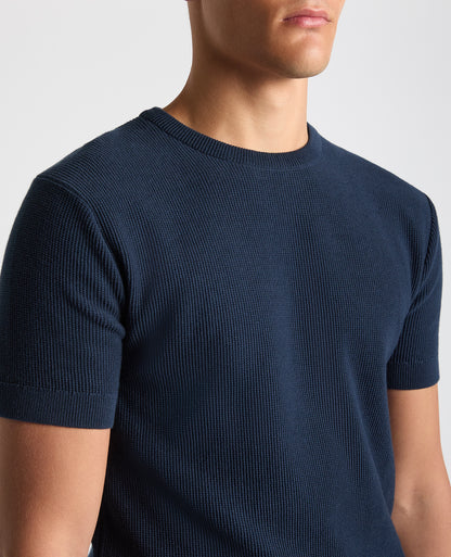 Man wearing a navy Slim Fit Wafffle Knitted Tee