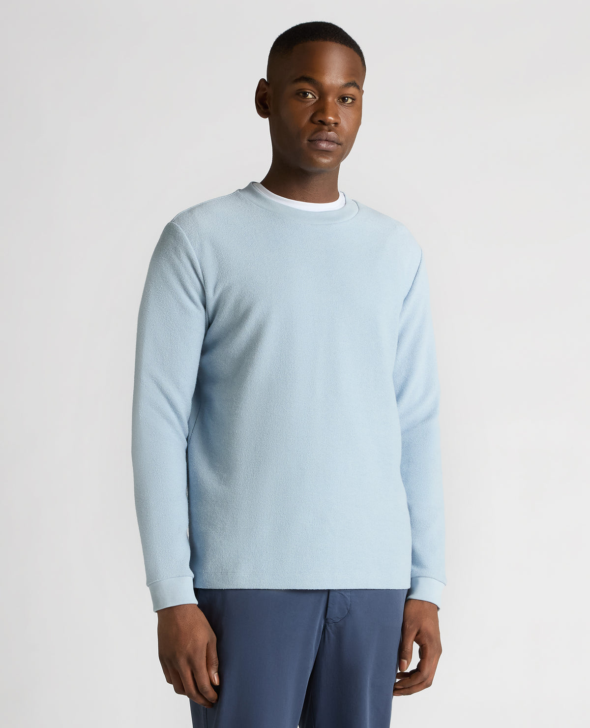 Man wearing a blue Tapered Fit Cotton Micro Waffle Sweatshirt