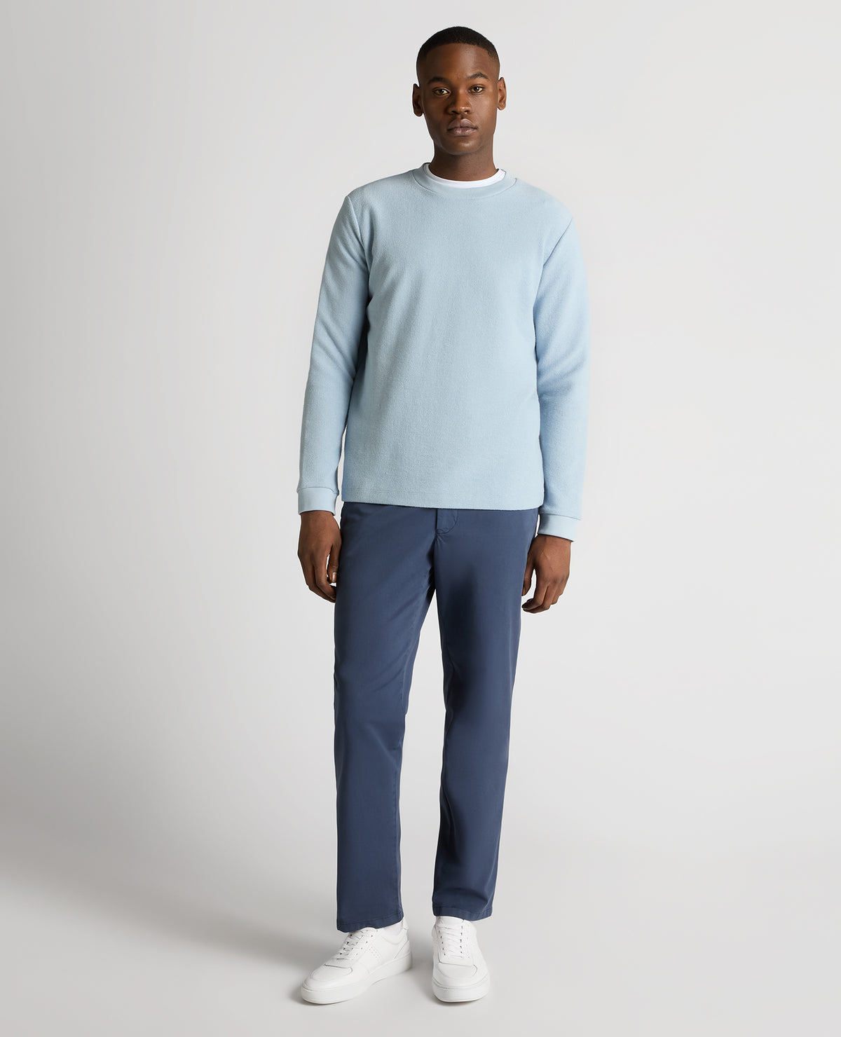 Man wearing a blue Tapered Fit Cotton Micro Waffle Sweatshirt