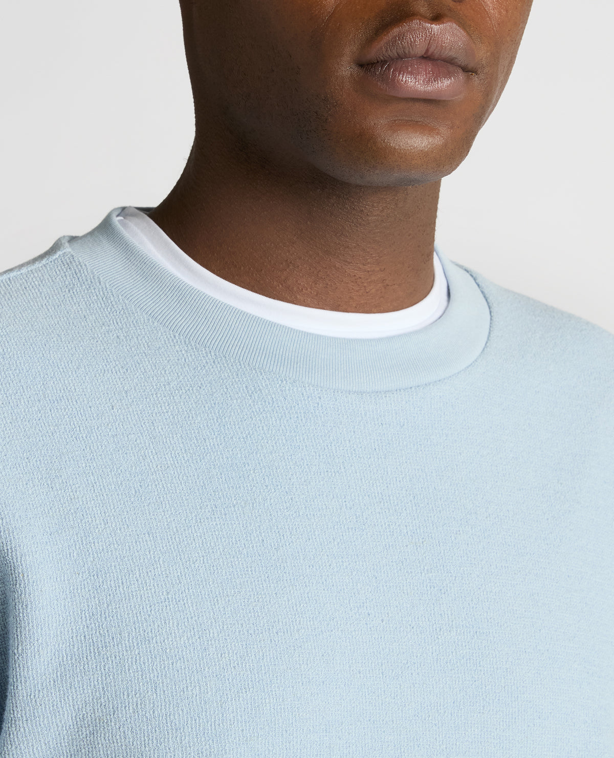 Man wearing a blue Tapered Fit Cotton Micro Waffle Sweatshirt