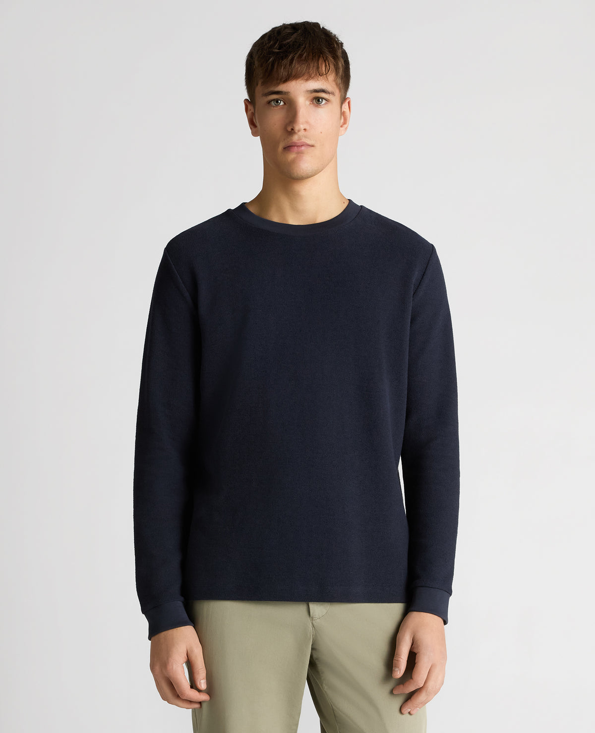 Man wearing a navy Tapered Fit Cotton Micro Waffle Sweatshirt