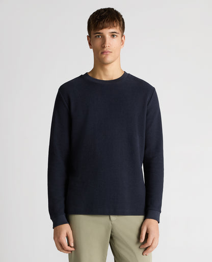 Man wearing a navy Tapered Fit Cotton Micro Waffle Sweatshirt