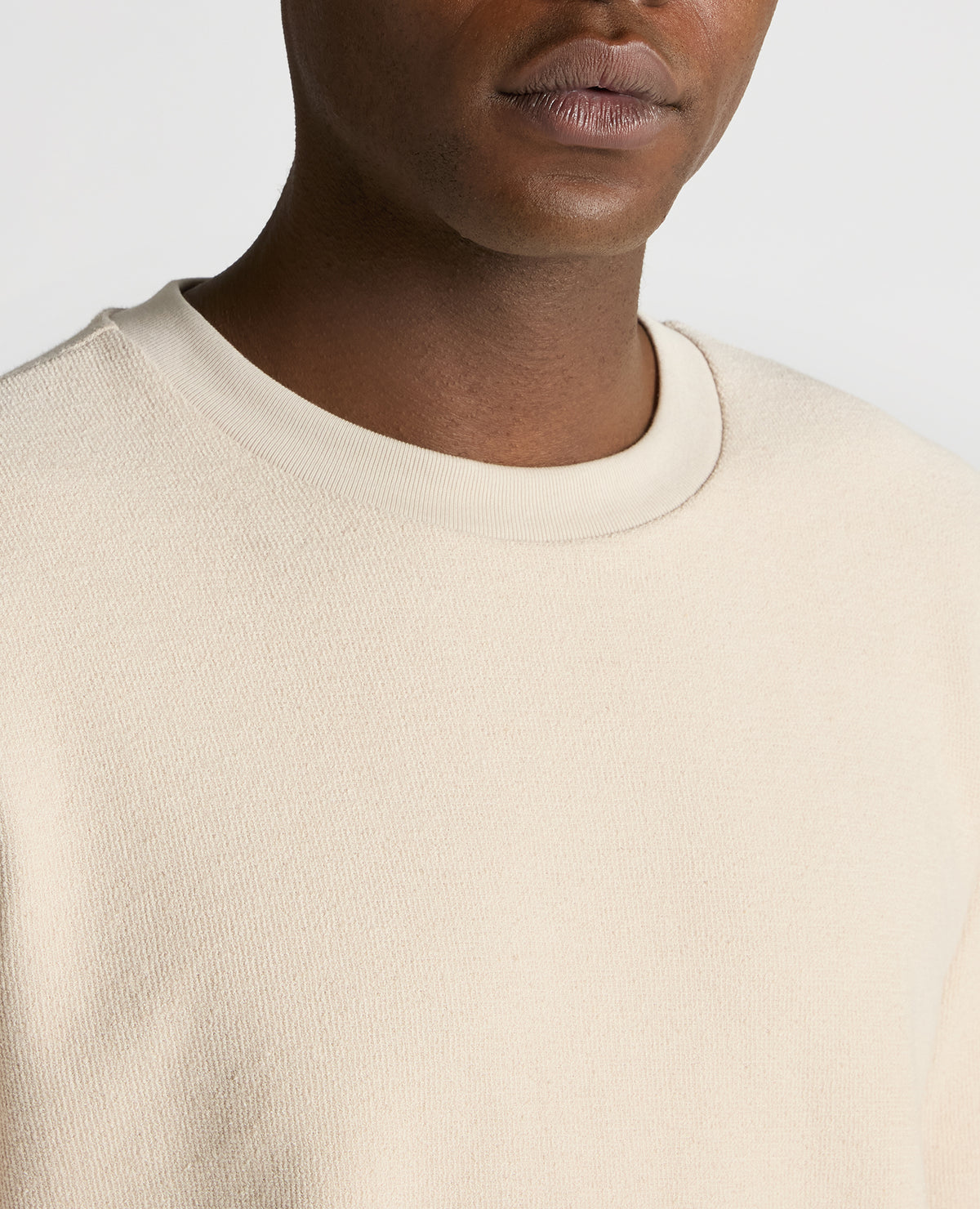 Man wearing a sand Tapered Fit Cotton Micro Waffle Sweatshirt