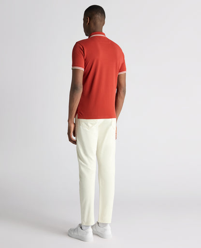 Man wearing a orange Tapered Fit Cotton-Stretch Polo Shirt