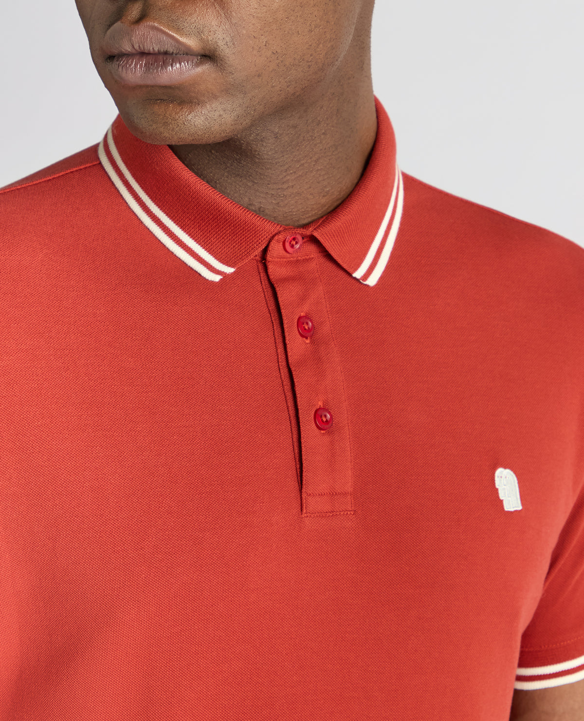Man wearing a orange Tapered Fit Cotton-Stretch Polo Shirt