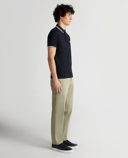 Man wearing a navy Tapered Fit Cotton-Stretch Polo Shirt
